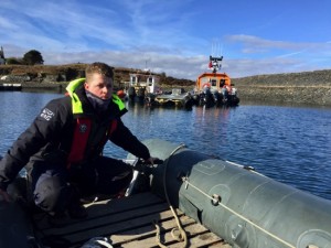 Learning to drive the dinghy in the safety of Easdale harbour